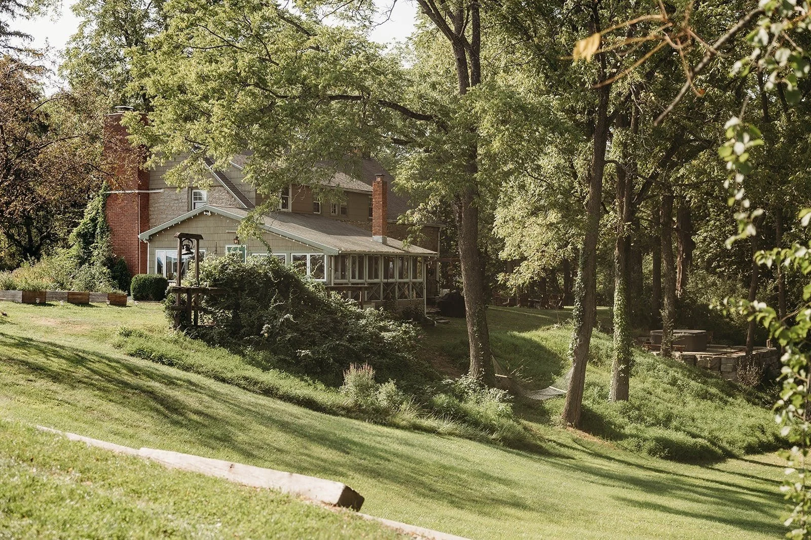 An expansive view of a country manor house on a hillside