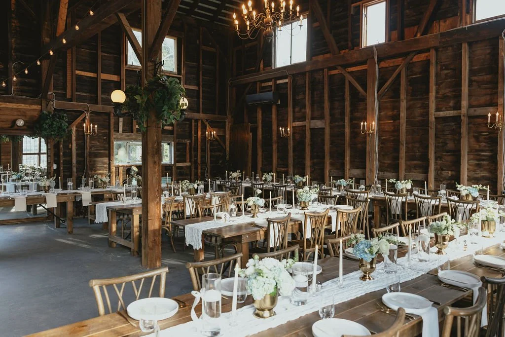 An elegant dining setup with white and blue florals at Black Walnut Farm