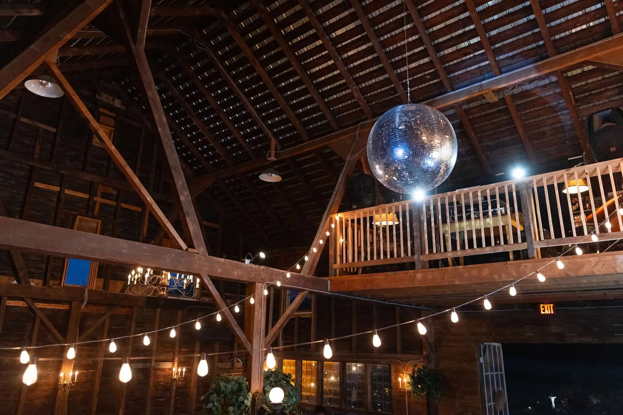 a shimmer disco ball floats above a dance floor
