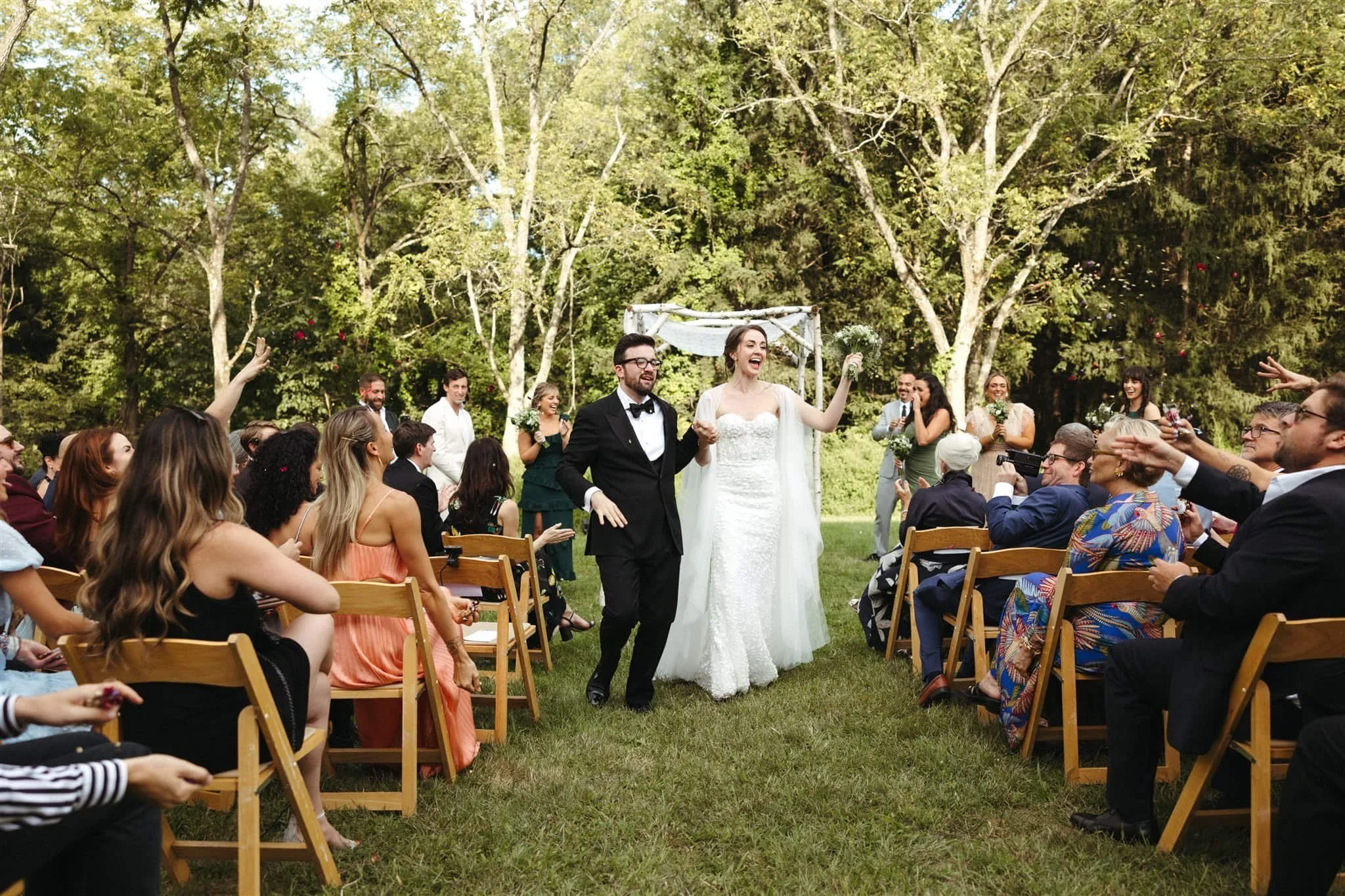 a bride and a groom having a wedding ceremony on the lawn