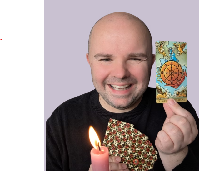Lee Hendricks from light nudges holding tarot cards and a candle