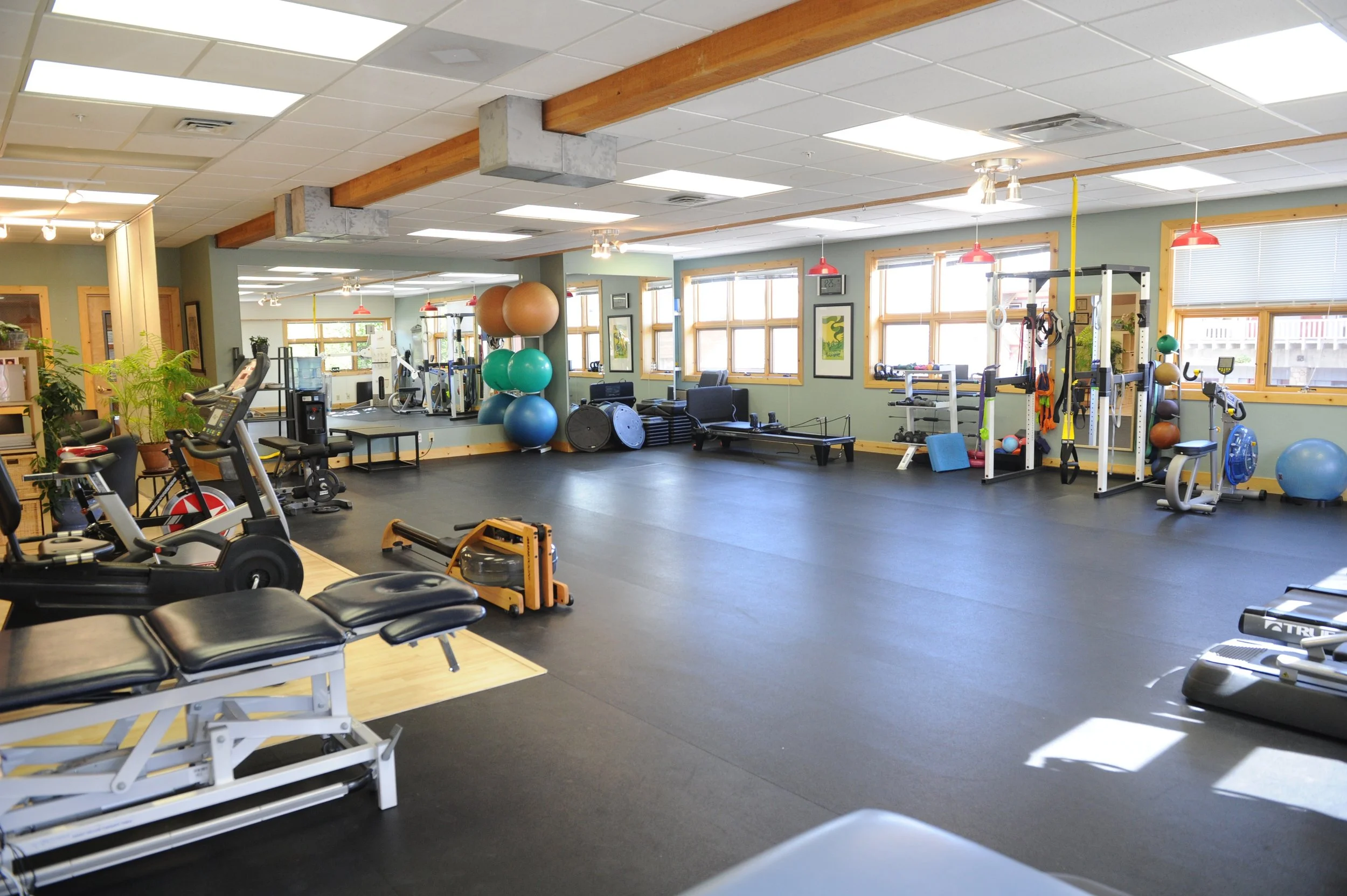 physical therapy clinic with fitness equipment and rubber flooring