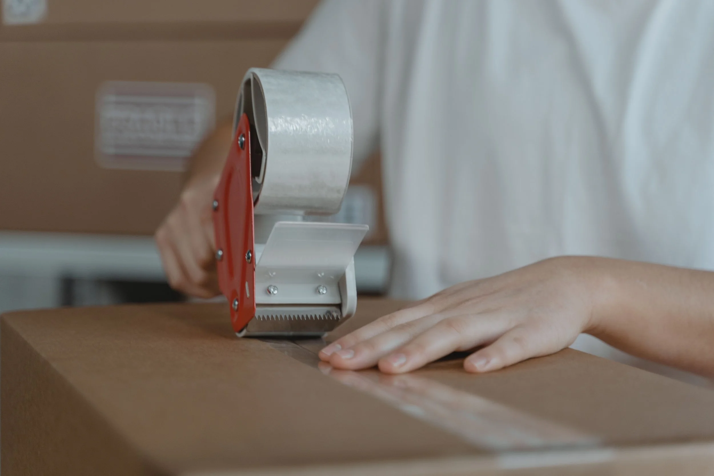 Packaging Tape 101: Hot Melt vs. Acrylic, Reinforced Tape, and Hand vs. Machine Application