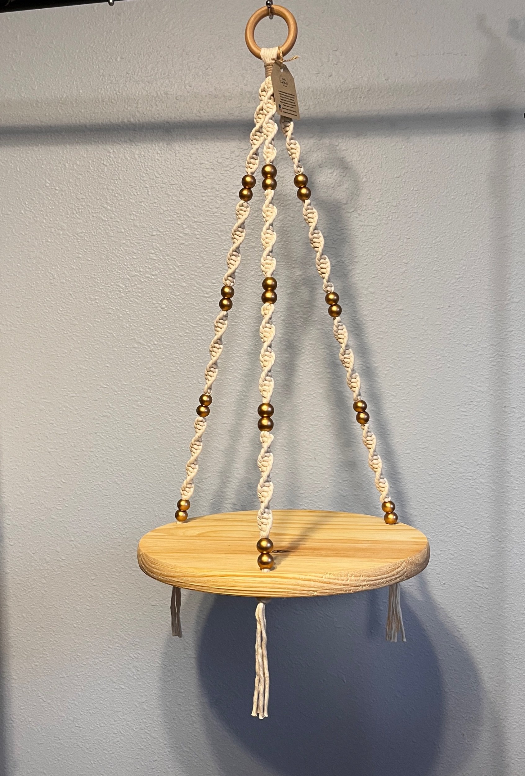 White beaded macrame hanging shelf