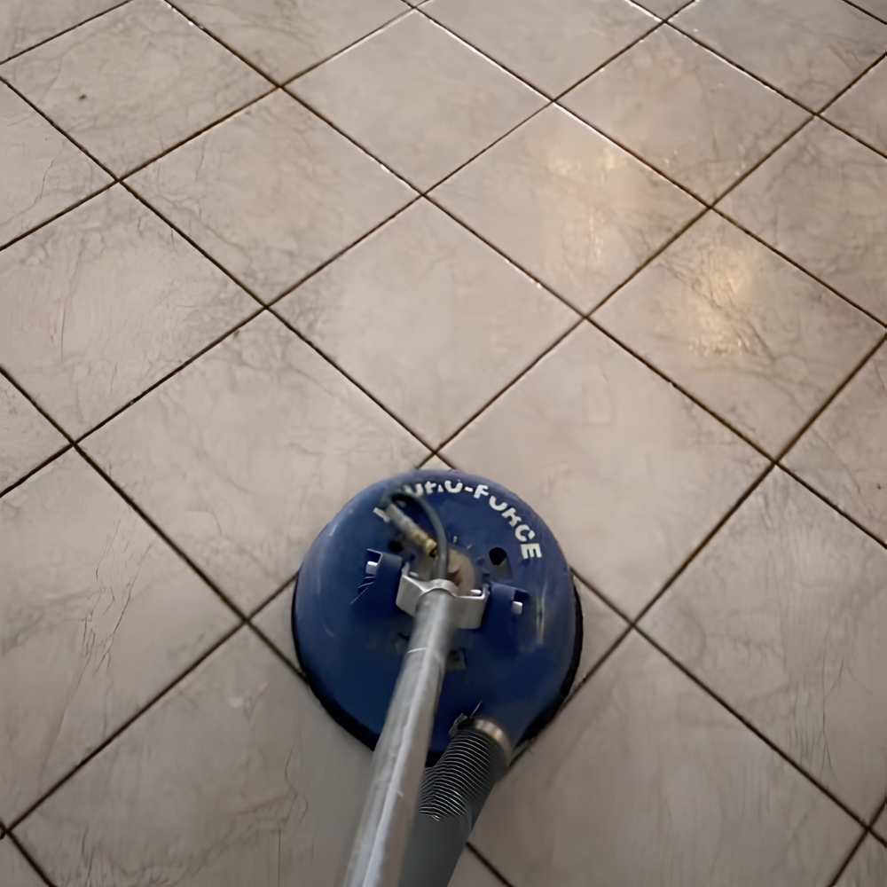 A blue and gray floor polishing machine on beige tile flooring.