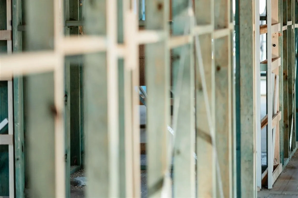 Close-up view of wooden framing studs in an unfinished building under construction.