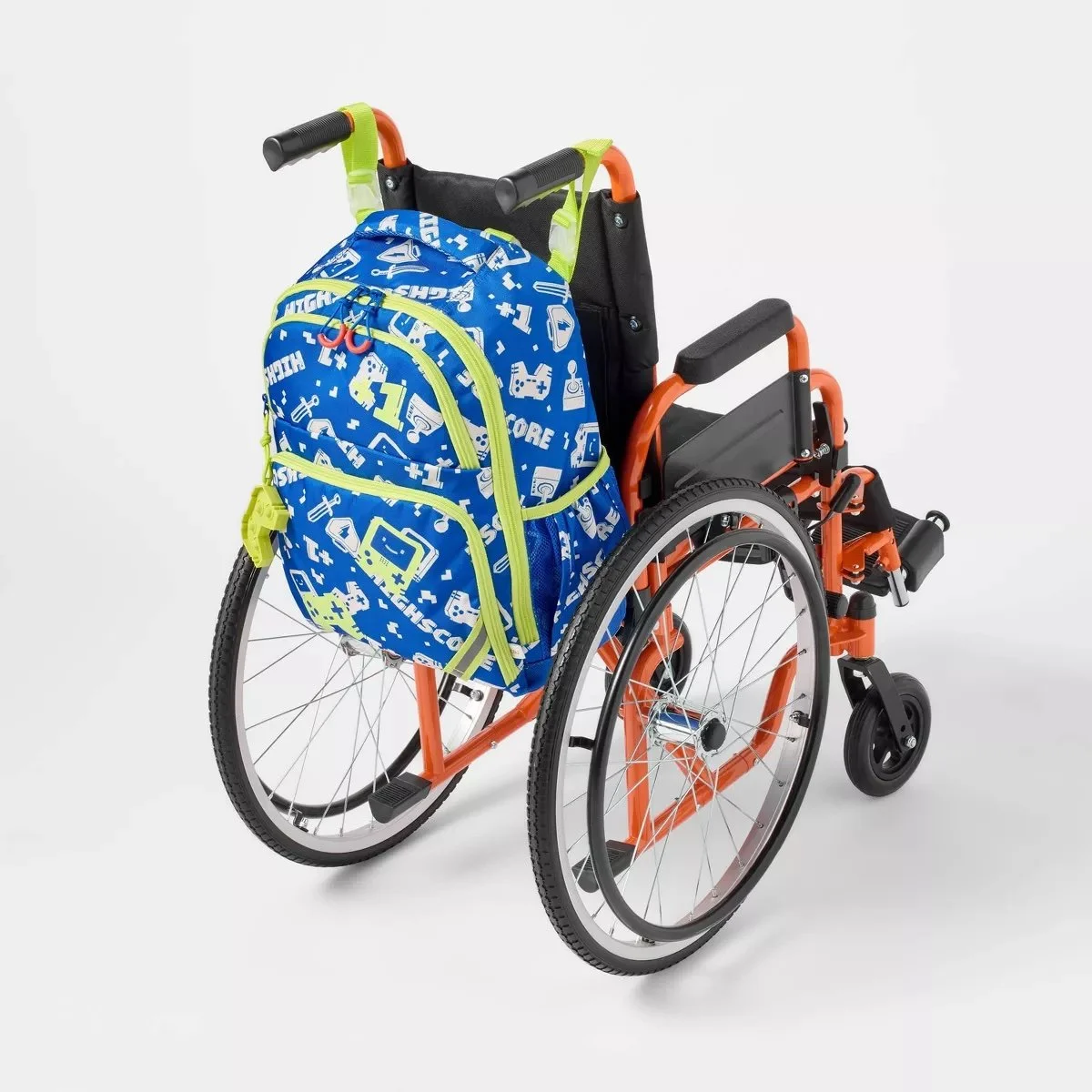 A bright blue backpack with neon green zippers and straps and a gaming pattern mounted on an orange and black wheelchair