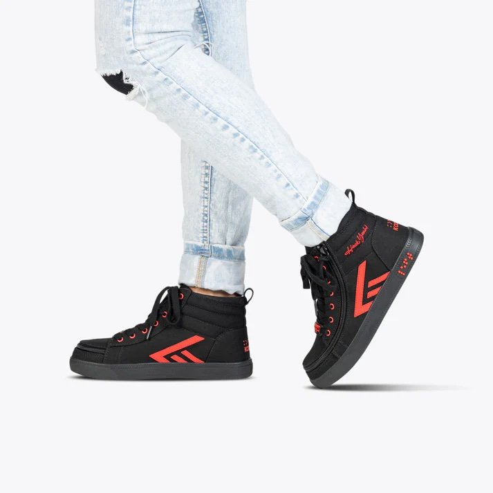 BILLY adaptive kids high top sneaker in black with red accents shown on a model with light wash jeans