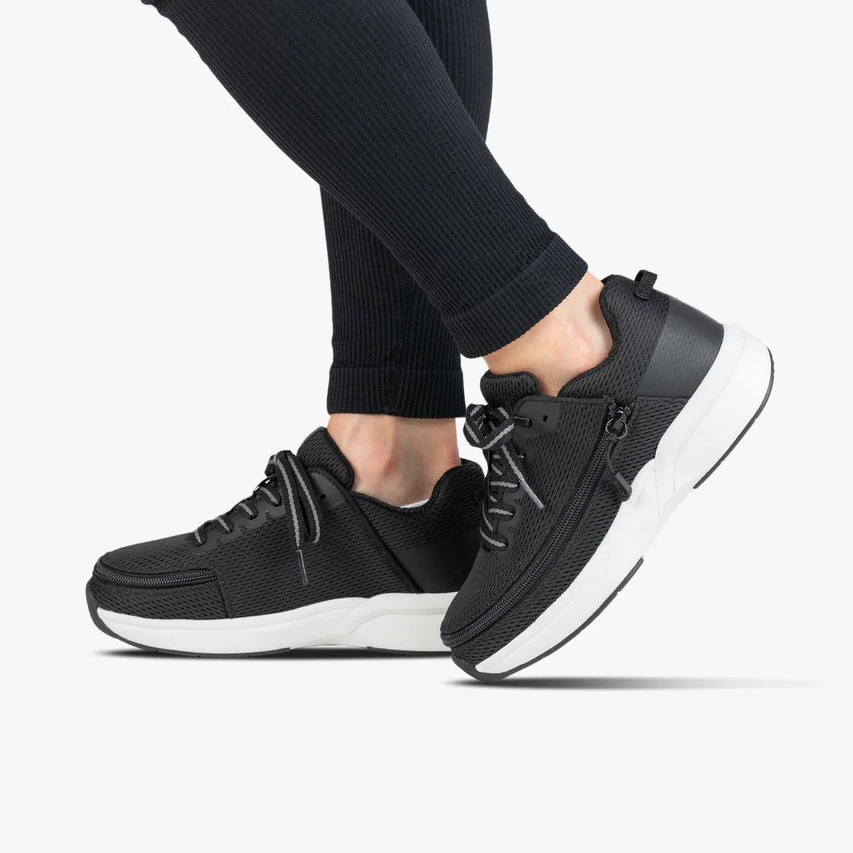 BILLY women's limitless shoe shown in black with a white rubber sole on a model wearing black leggings
