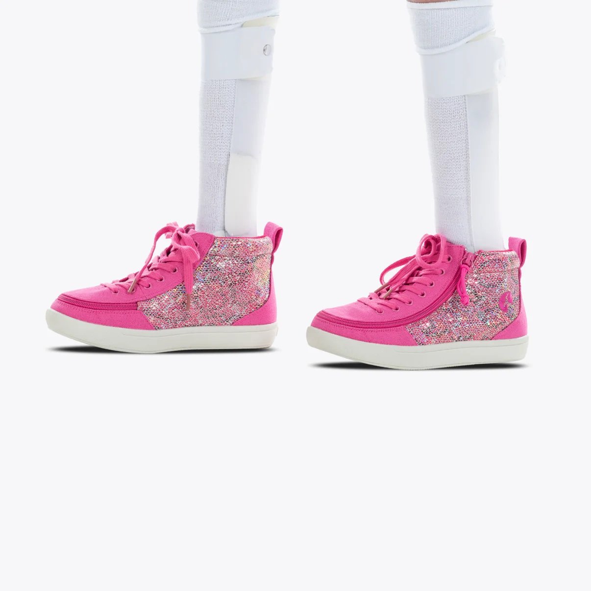 BILLY adaptive kids D|R High Top Sneaker shown fuchsia with a snake print up the inside and outside middle, pink laces, pink zipper, and a white sole shown on a model wearing AFO braces