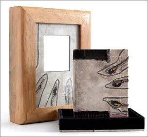 Wooden frame with The Raven book sitting in front set on a white background.