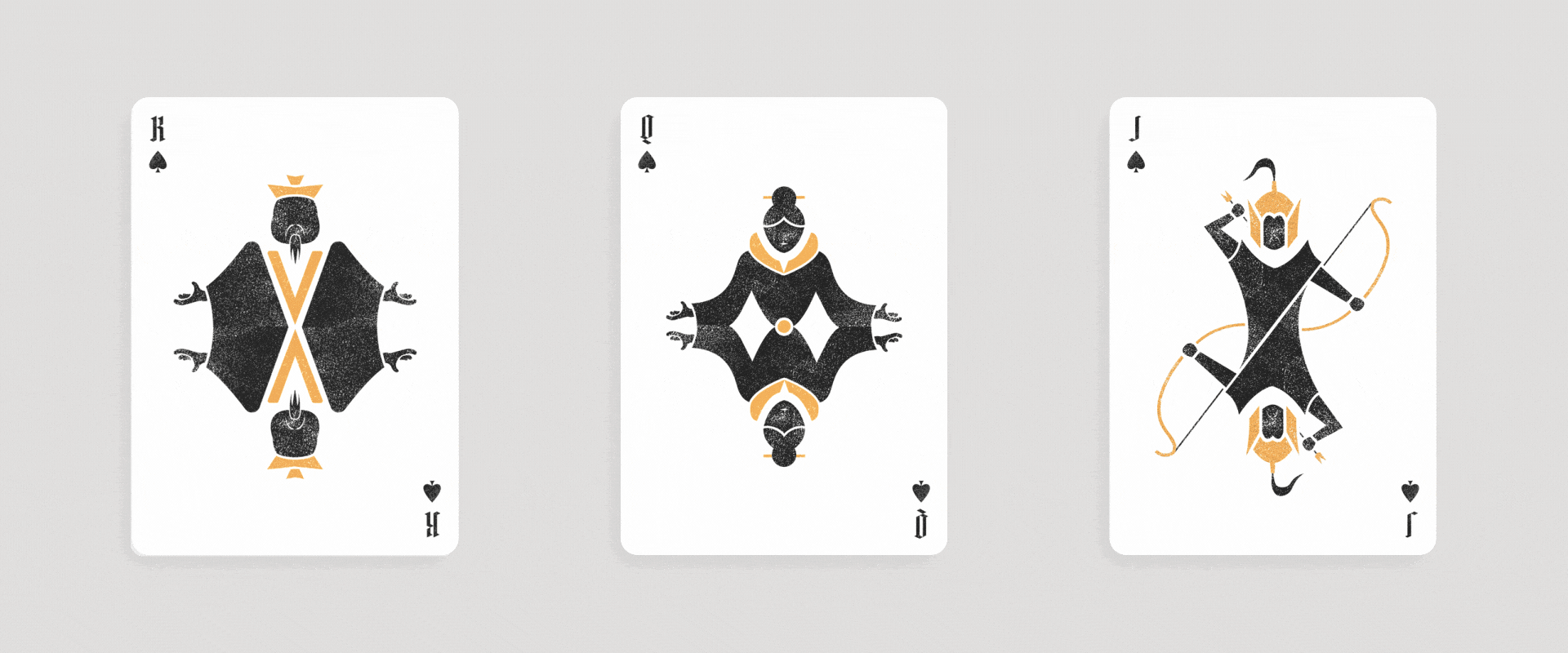 Play cards showing king of spades, queen of spades, and jack of spades on a gray background.