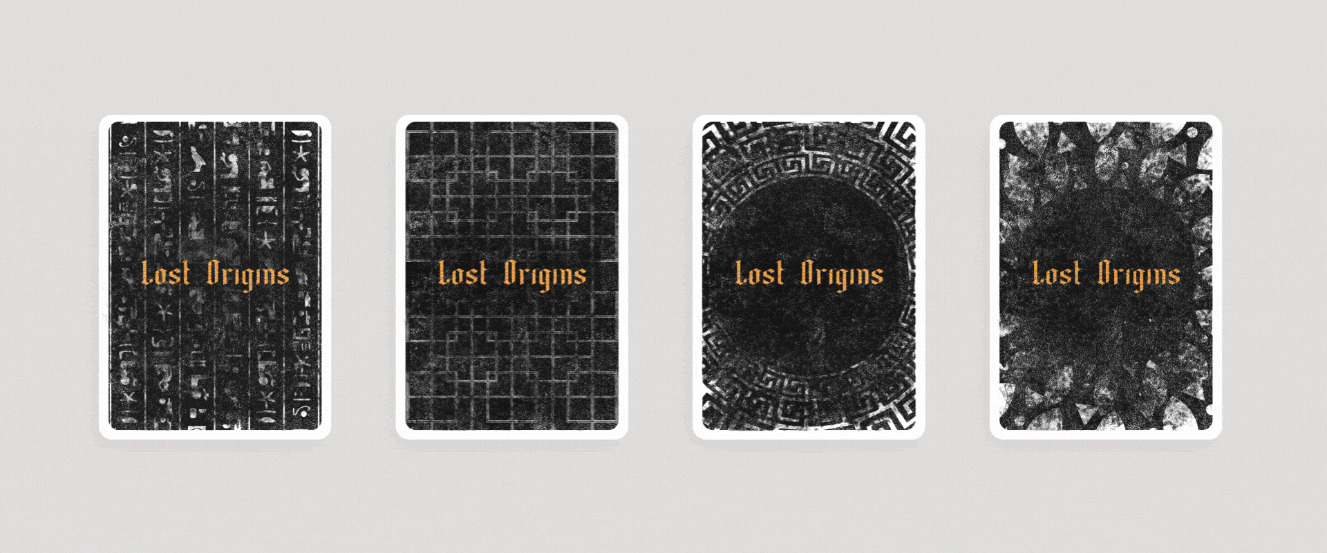 Four playing cards with black backgrounds and gold text that reads "Lost Origins" on each card. The cards feature various black and white intricate designs and patterns.