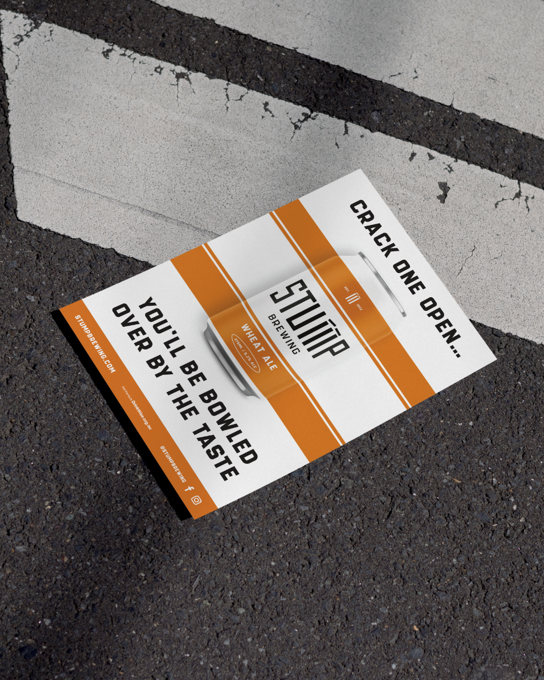 A flyer advertising a wheat ale beer called 'Stümp' with a message 'Crack one open... You'll be bowled over by the taste'. the flyer features a stylized beer glass and is lying on a cracked asphalt surface with a painted white line.