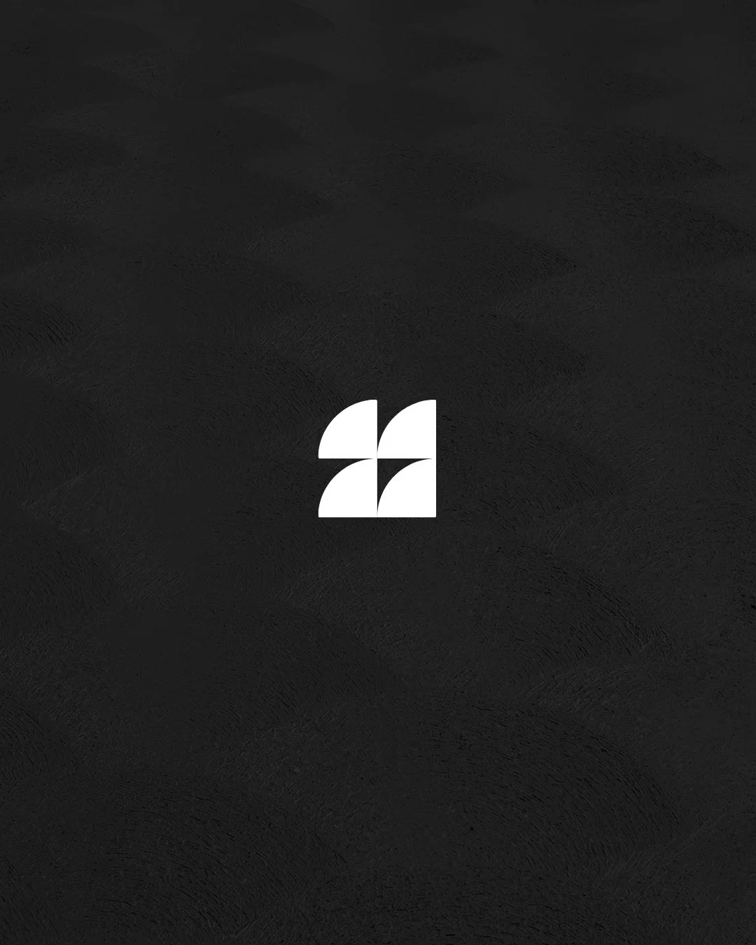 Minimalist black background with a small, white geometric logo in the center