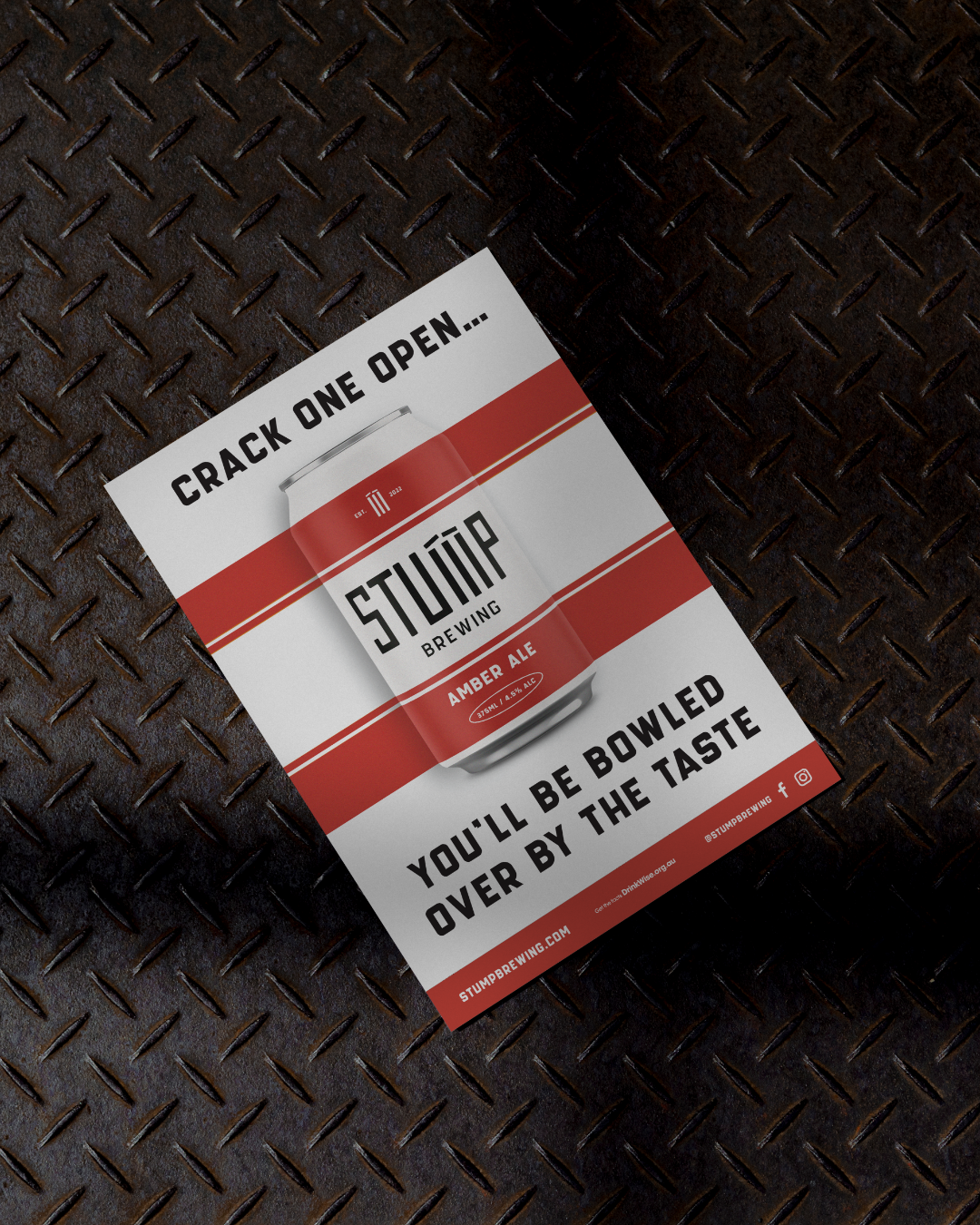 A promotional flyer for Stump Brewing featuring a can of Amber Ale with the text "Crash One Open..." at the top and "You'll Be Bowled Over By The Taste" at the bottom, placed on a dark, textured metal surface.