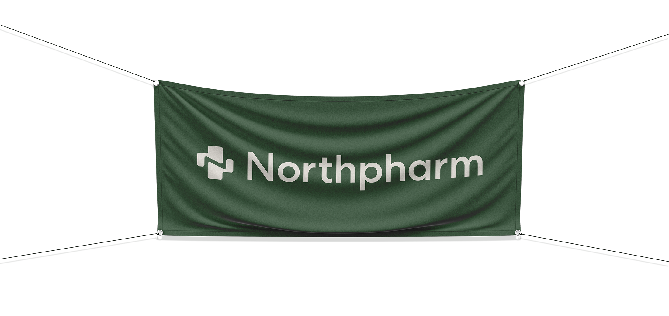 Green banner with the Northpharm logo and text hanging in a dark room.