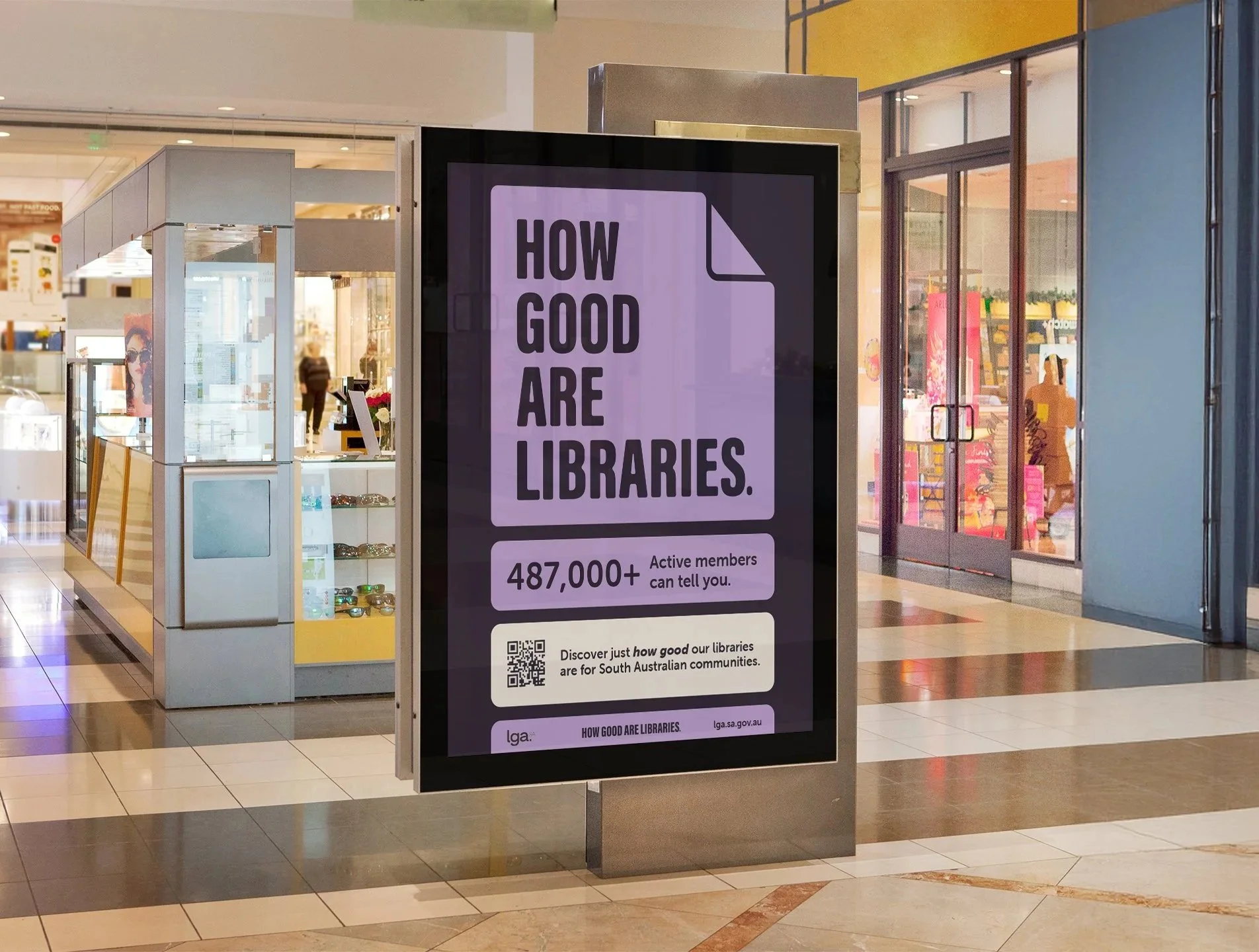 Digital sign inside a shopping mall promoting libraries with the message 'How good are libraries,' and indicating over 487,000 active members.