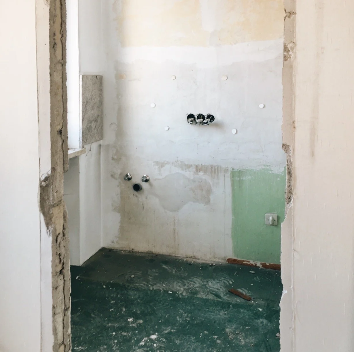 Chantier : l'ancienne salle de bain déposée, murs et sol mis à nu avant la reprise complète
