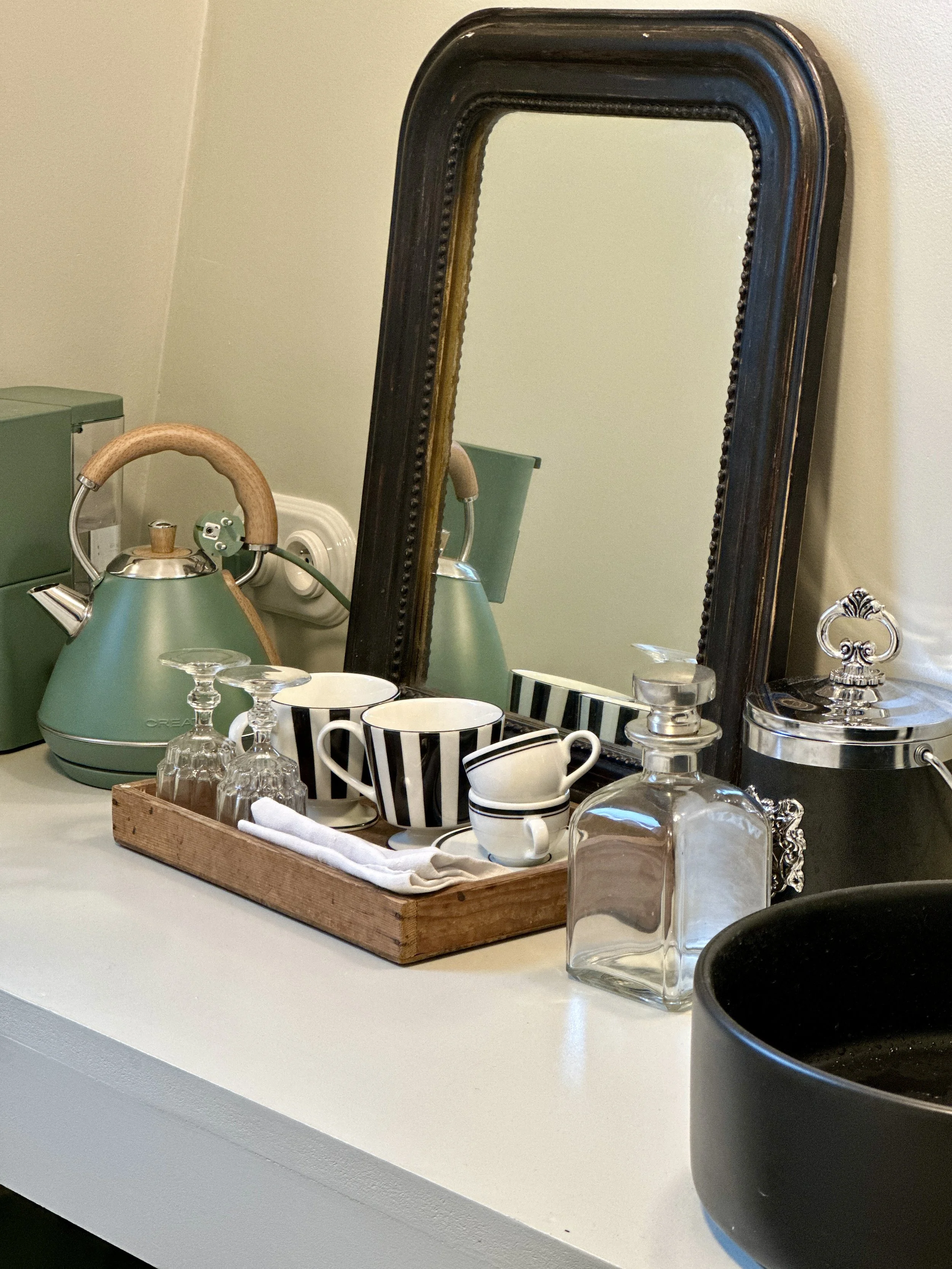 Coffee corner with espresso machine and kettle in a tiny Paris studio.