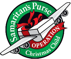 A circular logo for Samaritan's Purse Operation Christmas Child featuring a white shipping box, a rolled-up scroll, with green and red text and accents.