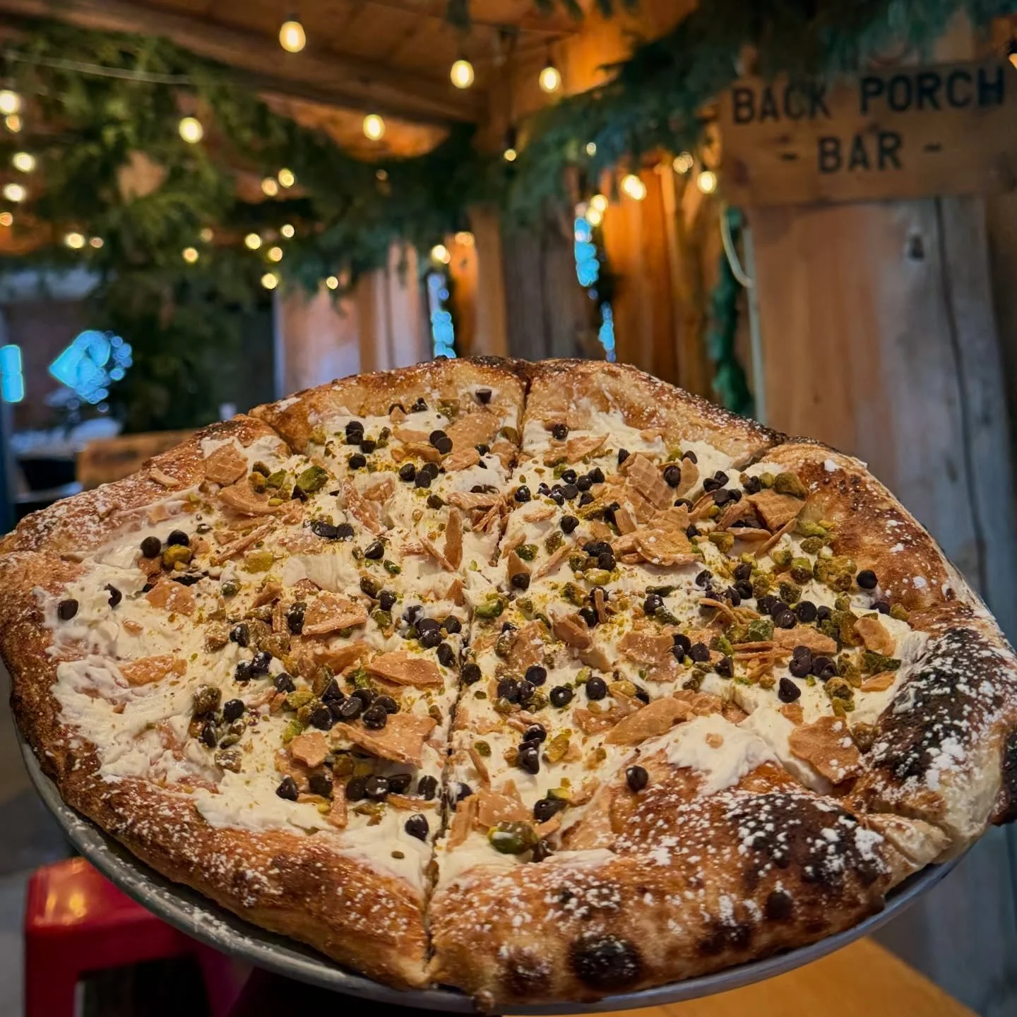This Cannoli Dessert pizza is literally OUT of this world!!! 
Sweet cream ricotta on a br&ucirc;l&eacute;ed crust with pistachio, chocolate chips and cannoli pieces. Not too sweet&hellip;utter perfection&hellip;I cannot even!!!🤤
