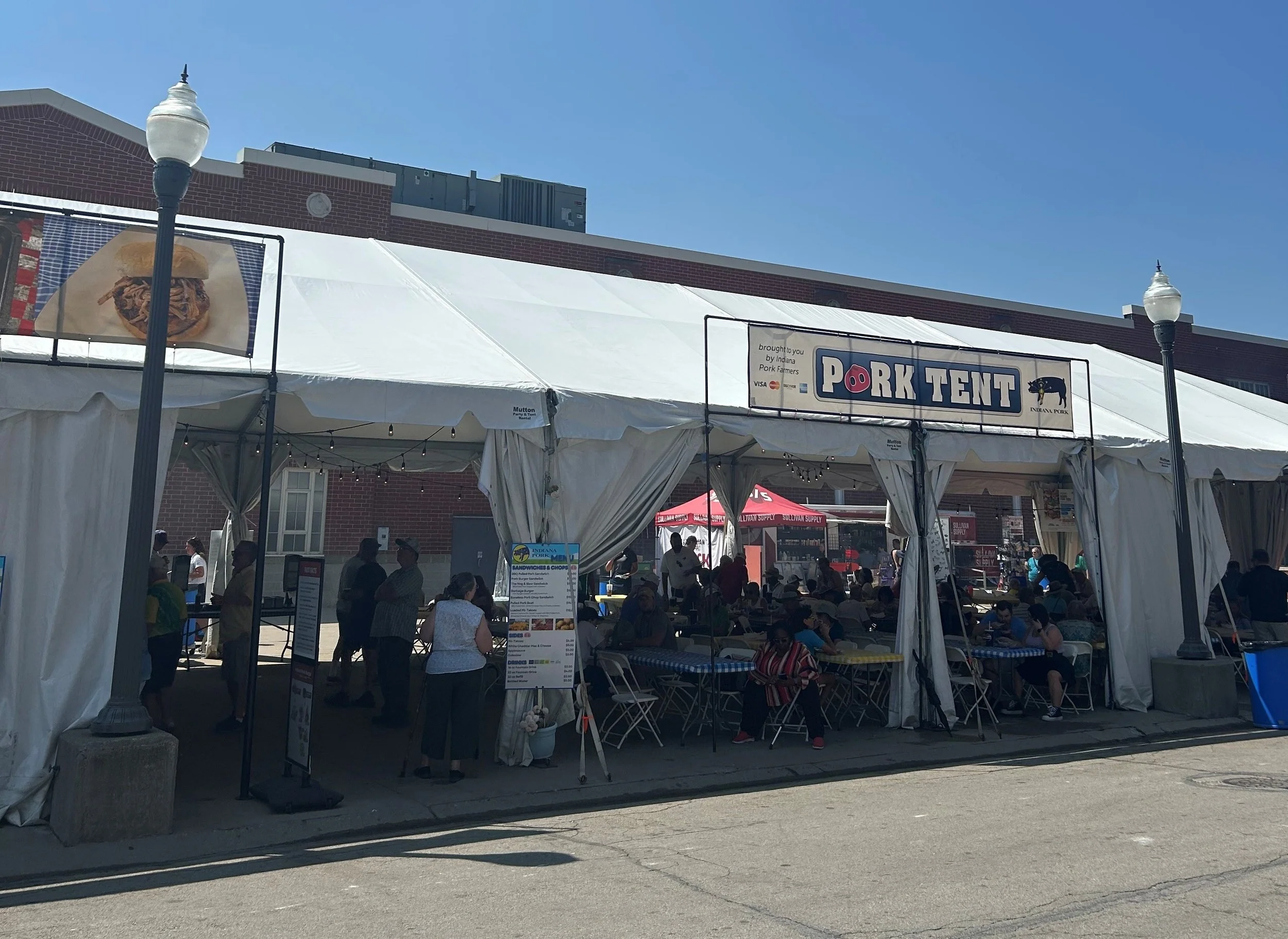 People working inside a concession tent