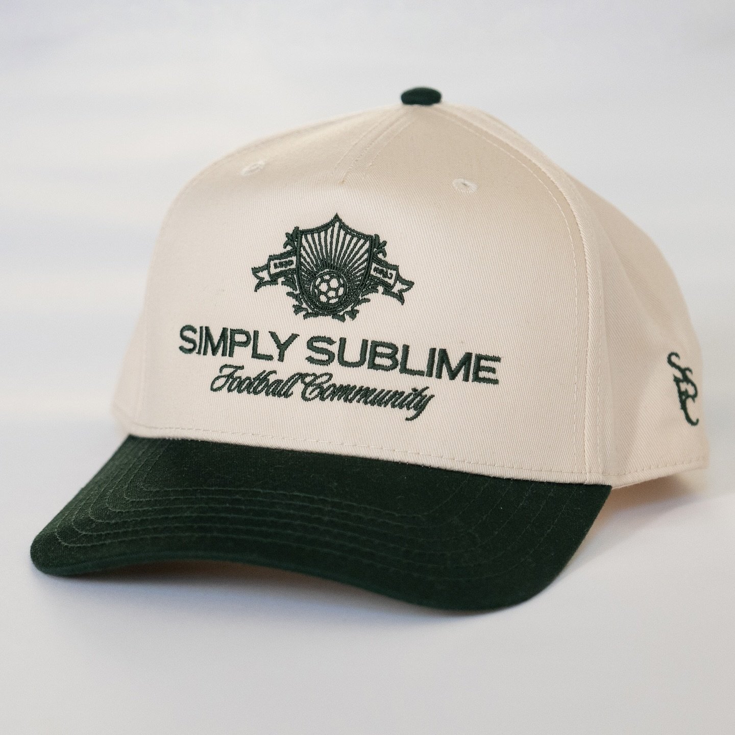 Our hats. 

The SSFC Dad Hat is just what it sounds like, your classic, simple, every day hat your dad would wear. Featuring our secondary logo embroidered on the front and our monogram on the side. 

The SSFC Two-Tone Hat is the trendy teammate. Dar