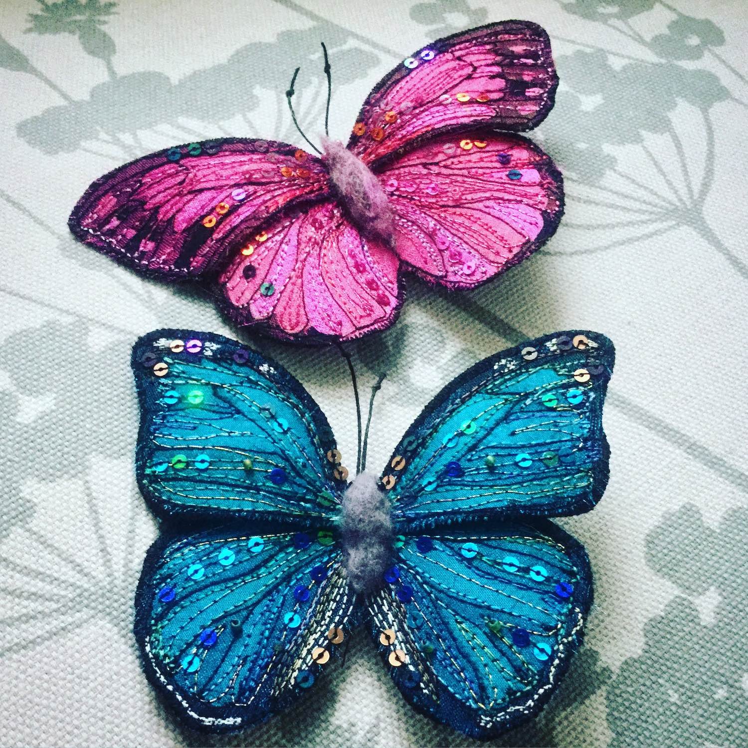 Pair of hand embroidered butterfly brooches