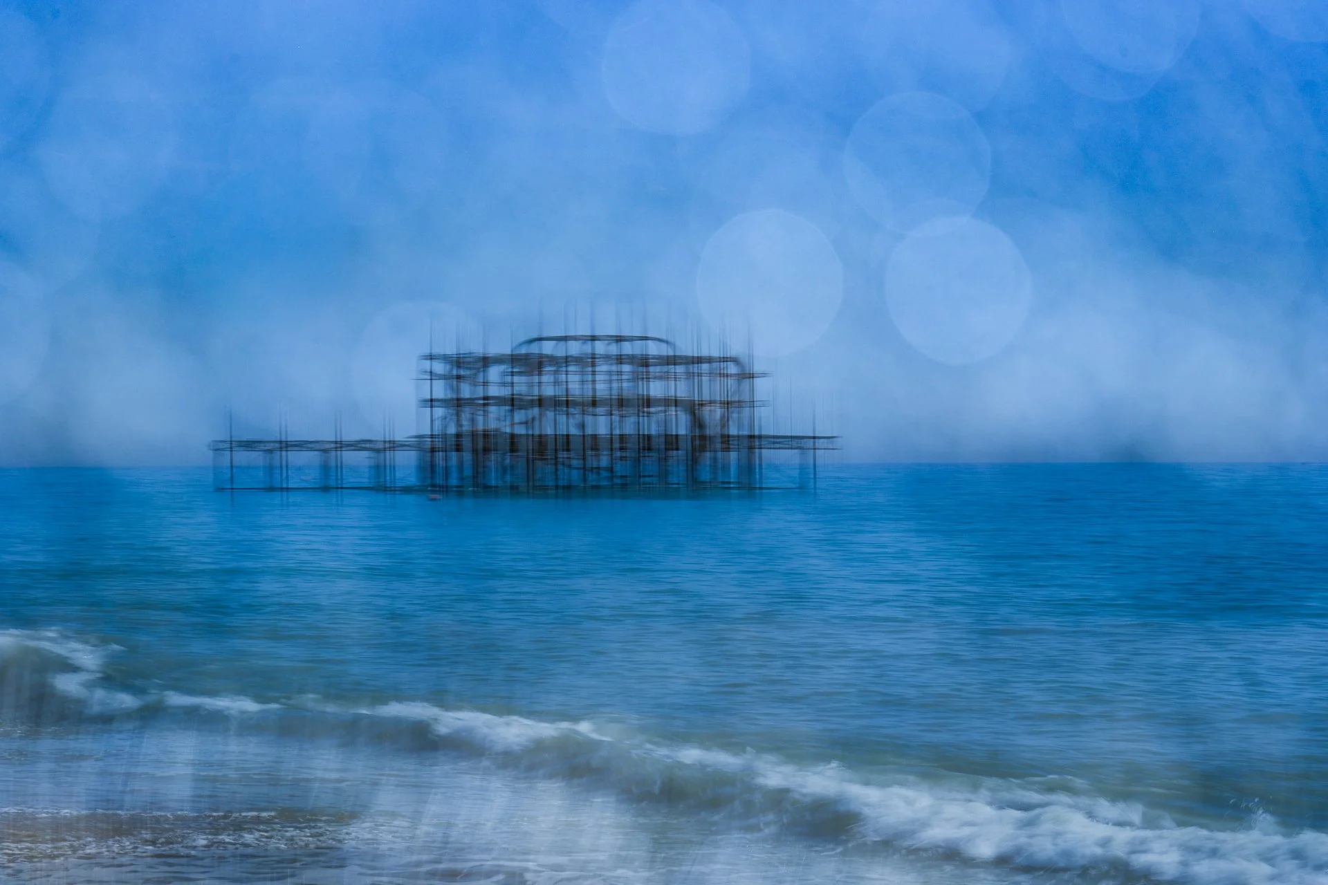In camera multiple exposure 📸

I've added two techniques together to create this image - the crosshatching of the West Pier and the sea and bokeh from the stones twinkling in the sunshine where the tide had left them wet.  I love Brighton for a phot