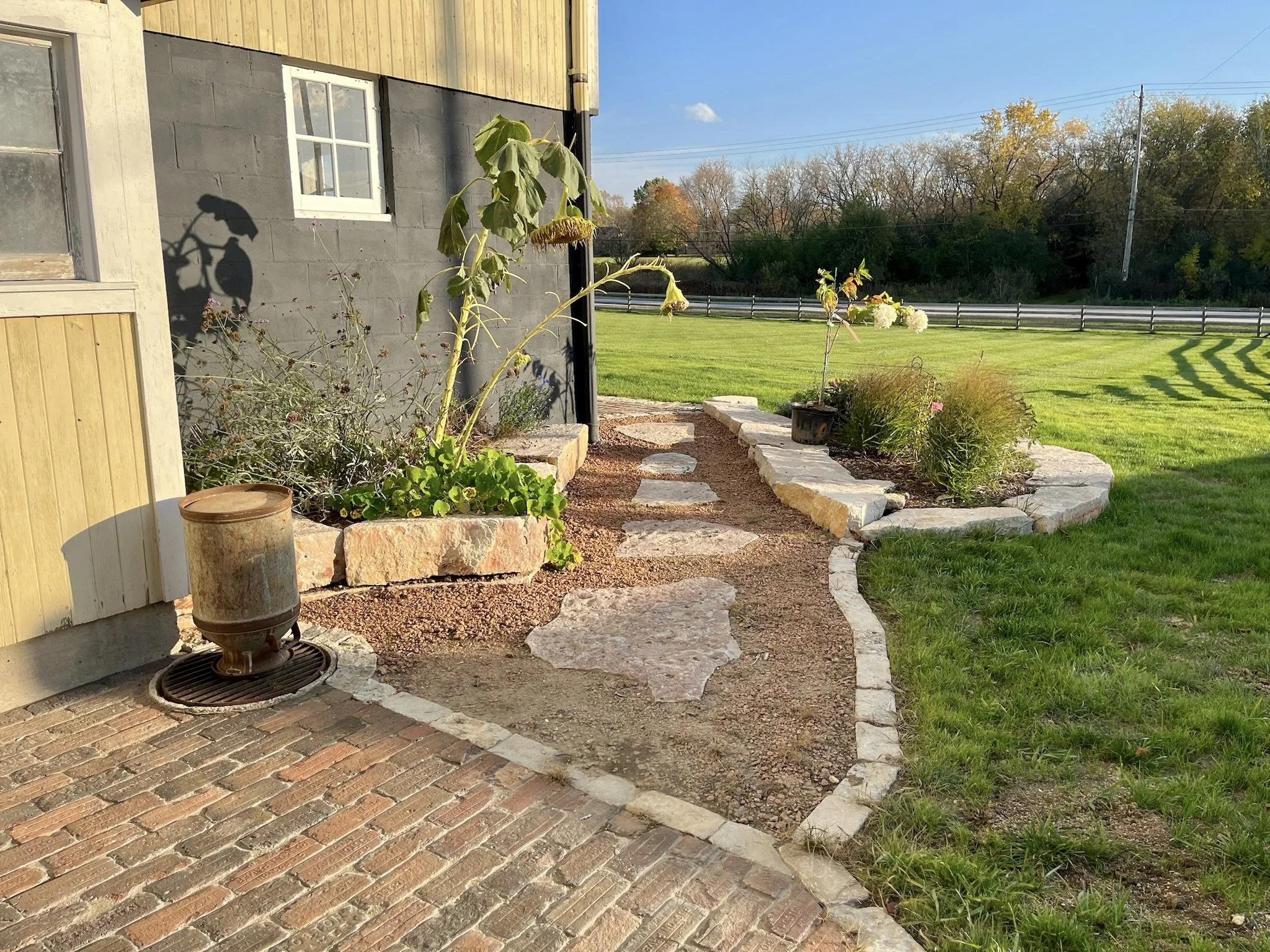 Flagstone walkway and stone planting beds