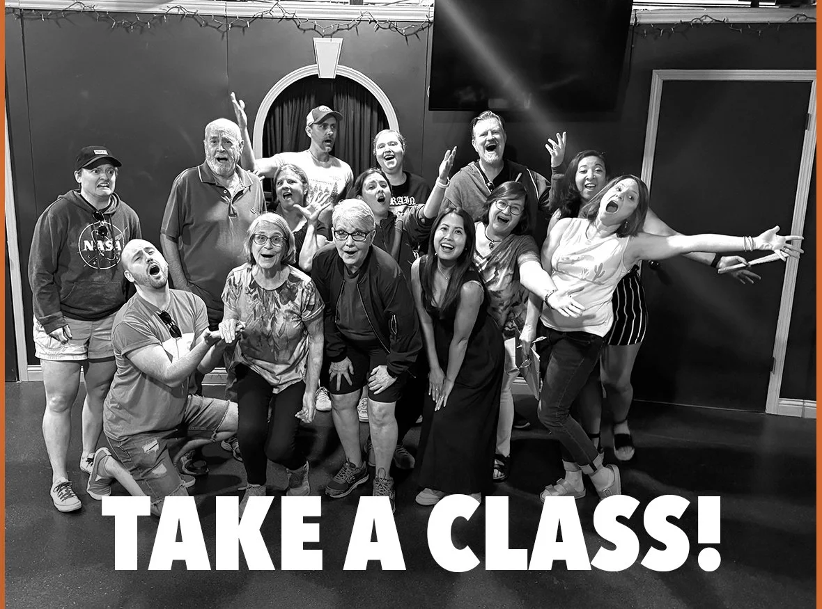 Group of people posing excitedly together, with the text 'TAKE A CLASS!' below them.