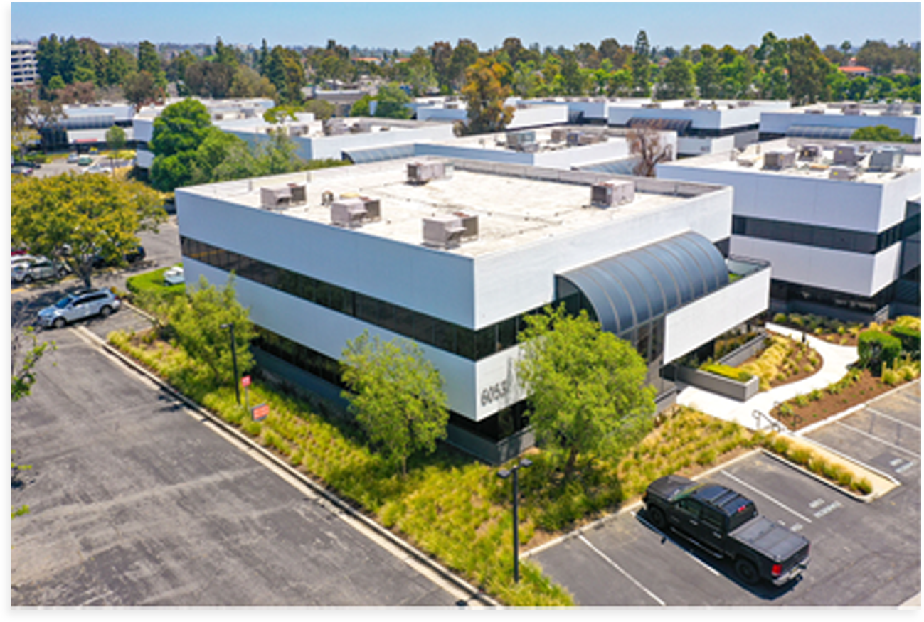 Aerial view of a commercial office building in a business park.