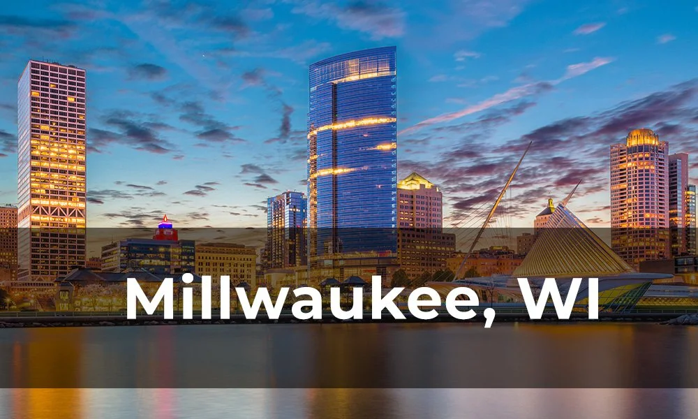 Skyline of Milwaukee, Wisconsin, featuring modern high-rise buildings and the Milwaukee Art Museum with its wing-like structure, during sunset.