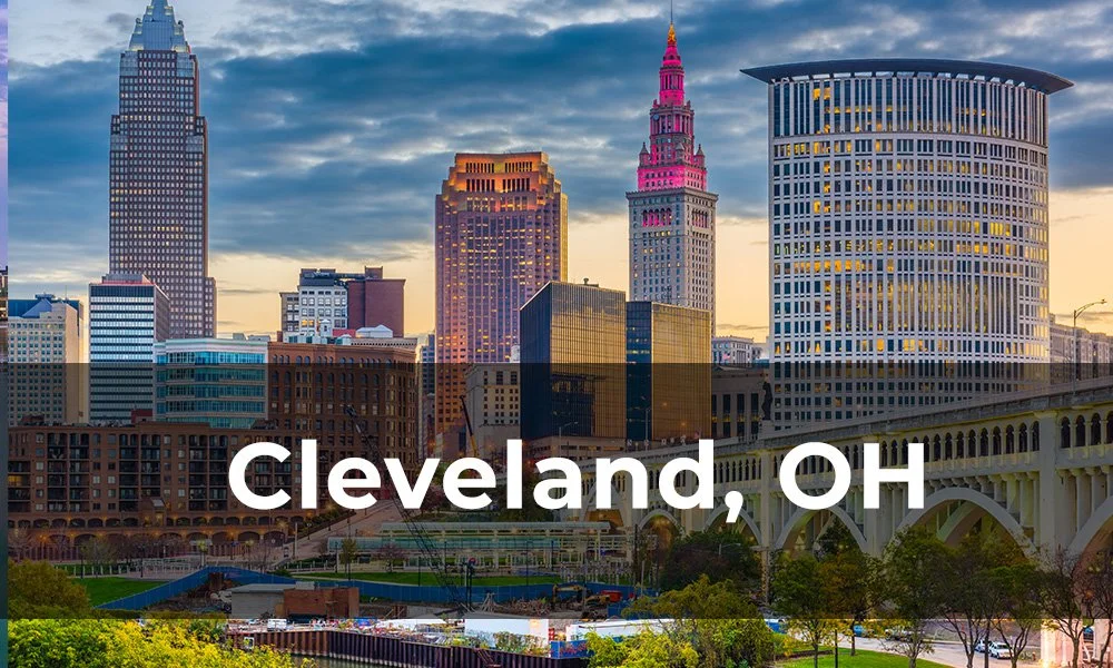 Skyline of Cleveland, Ohio with tall buildings and a bridge at sunset