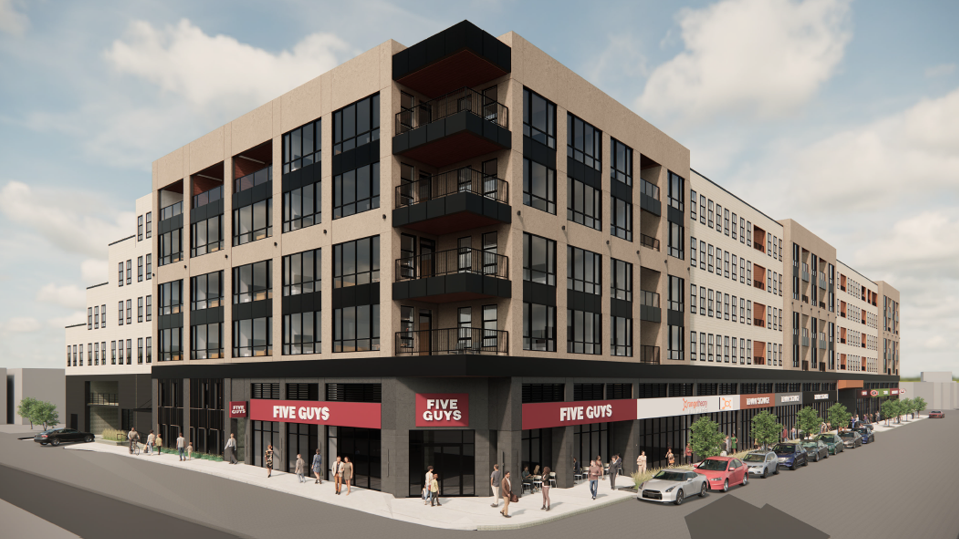 Modern multi-story building with retail stores including Five Guys on the ground floor, featuring large windows and people walking nearby.