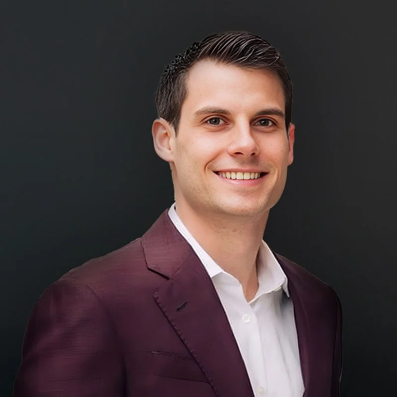 Smiling man in a suit against a black background