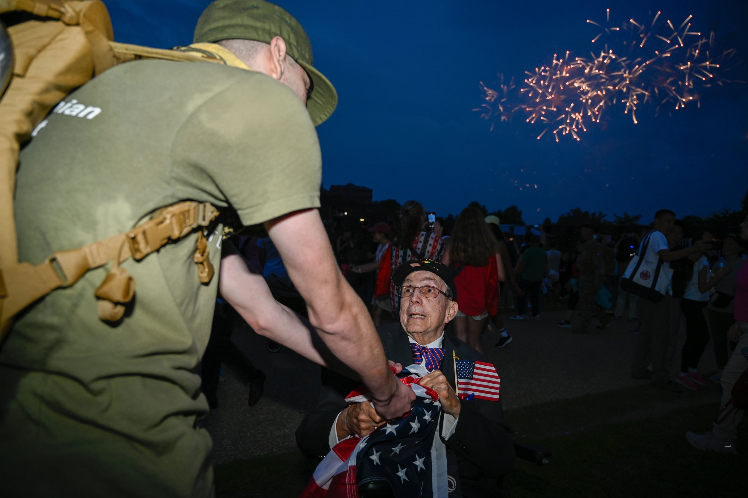 A Vietnam veteran pulls an American flag away from Elliot Latzsch, a Marine veteran, in Washington, D.C., on June 14, 2025. Latzsch stood outside the exit of the Army's 250th birthday celebration and said he was holding the flag upside down to signal