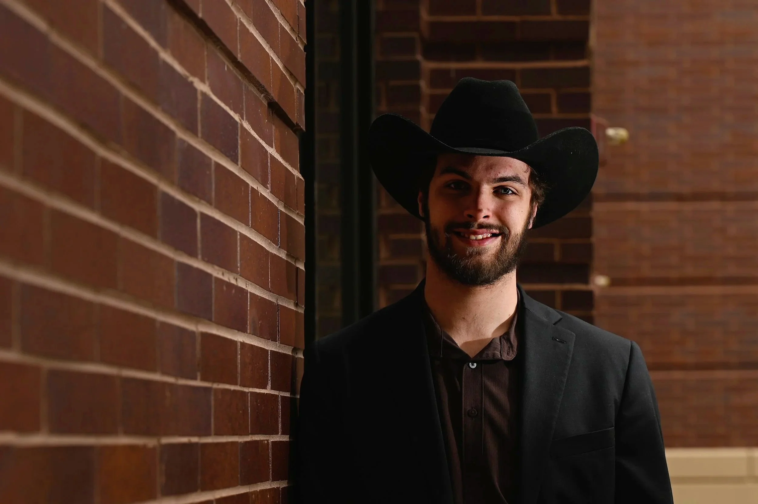 Marco Marchiando, president of Turning Point USA at UW Oshkosh, poses for a portrait outside of Sage Hall, where he attends political science classes, in Oshkosh, Wis., on April 9, 2025. Marchiando decided to form a Turning Point group at UWO after m