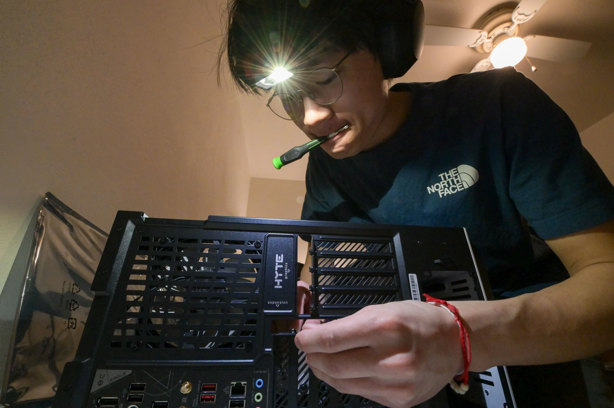 Kenneth Lee works on building his new computer in Appleton, Wis., Monday, March 30, 2026. One of his hobbies is gaming with his friends, most of whom are not Hmong. 