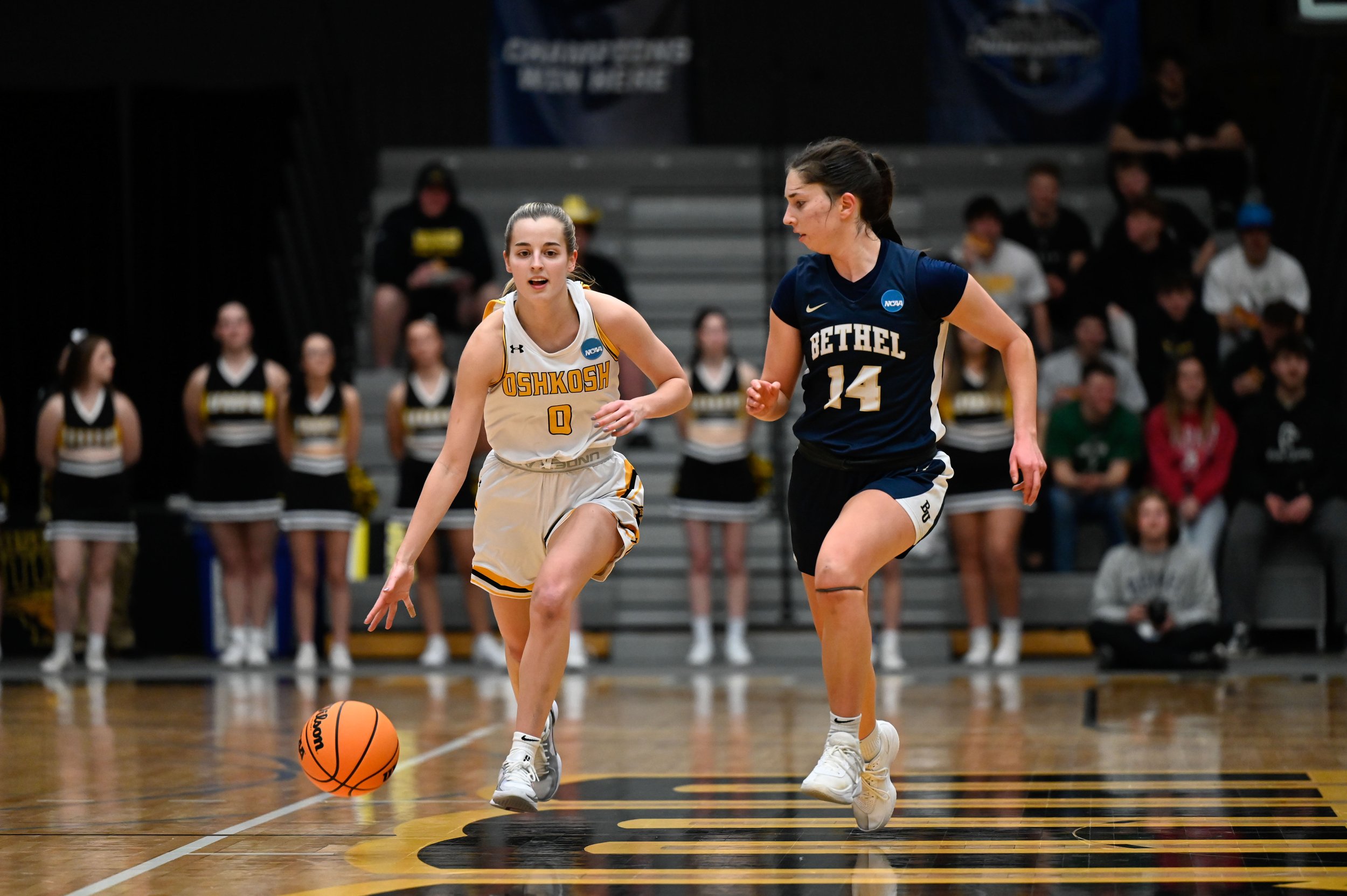 Kate Huml, a junior guard for the UW-Oshkosh women's basketball team, runs up the court as Anna Garfield, a guard for Bethel University, follows, at Kolf Sports Center in Oshkosh, Wisconsin on March 8, 2025. Huml broke a scoring drought in the first