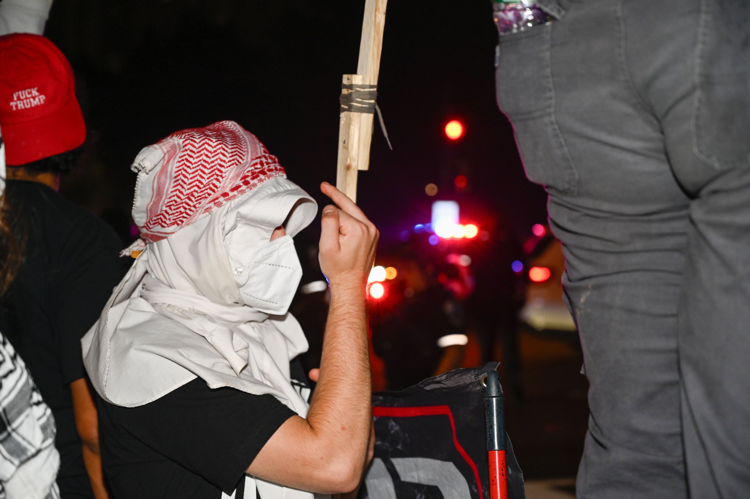 A protester raises his middle finger at police down the road from the Army's 250th birthday celebration in Washington, D.C., on June 14, 2025. The group of protesters were just one of the thousands of other planned national protests for "No Kings Day