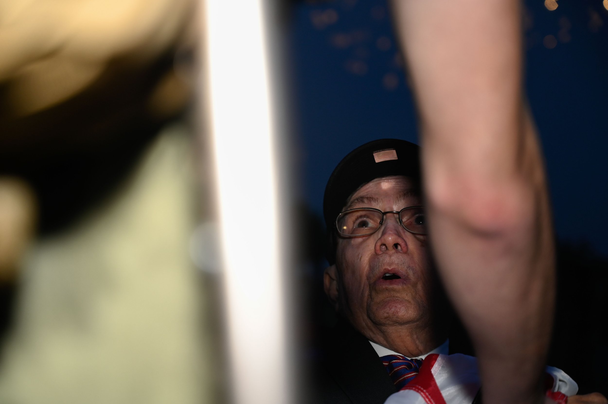 A Vietnam veteran argues with Elliot Latzsch, a Marine veteran, in Washington, D.C., on June 14, 2025. The Vietnam veteran approached Latzsch after exiting the Army's 250th birthday celebration and seeing him holding the flag upside down. The vetera