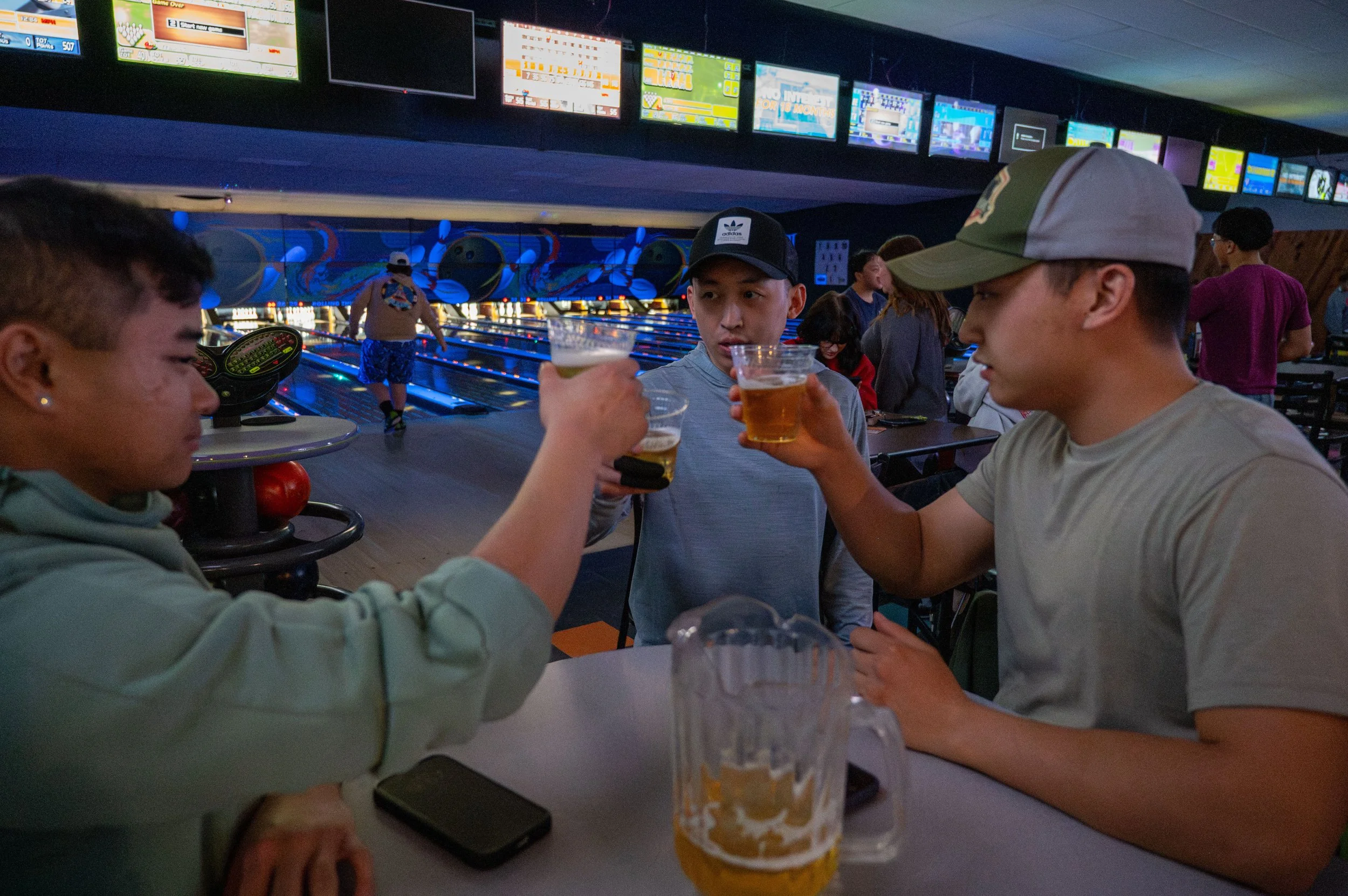 Karter Thor and his friends raise a glass as they bowl in Appleton, Wis., Friday, April 10, 2026. Though Thor spent his childhood embarrassed by Hmong events, as he’s grown older, he has become more involved and met several Hmong friends. 