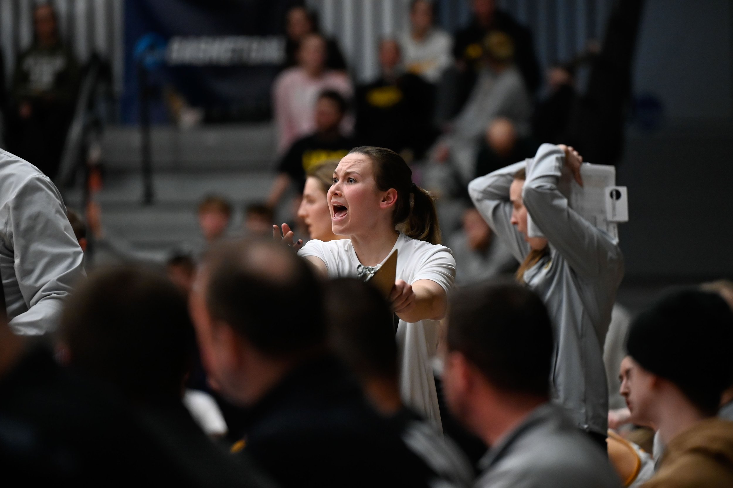 Bridget Froehlke, a senior guard for the UW-Oshkosh women's basketball team, holds out her arms in shock as the referees make a call she disagrees with at Kolf Sports Center in Oshkosh, Wisconsin on March 7, 2025. UWO was playing against Calvin Unive