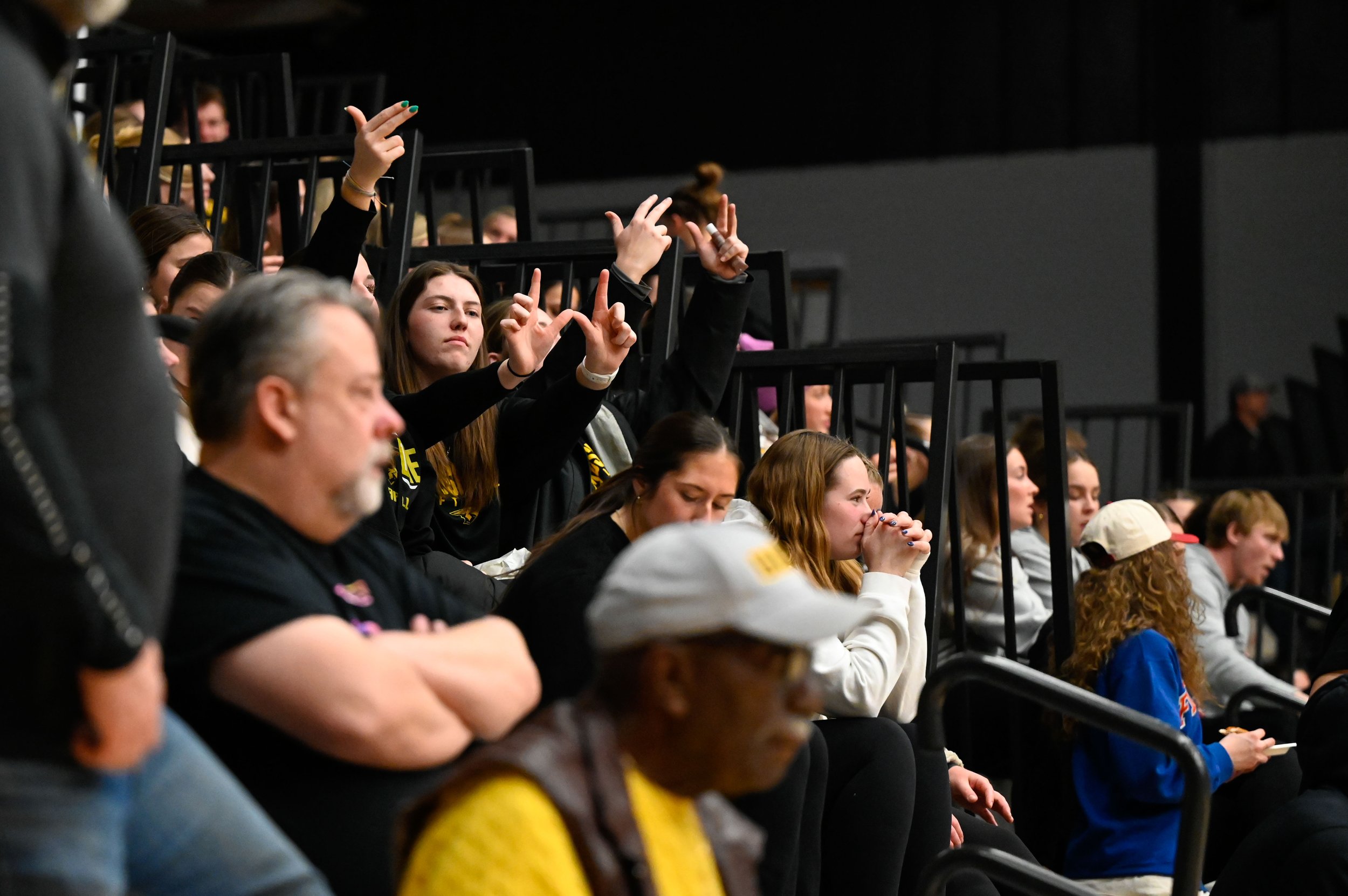 Students hold up their hands to signal a win for UW-Oshkosh against Calvin University at Kolf Sports Center on March 7, 2025. This was the first round in the 2025 NCAA Division III tournament for the Titans. (Photo by Advance-Titan Photo Editor Jessi