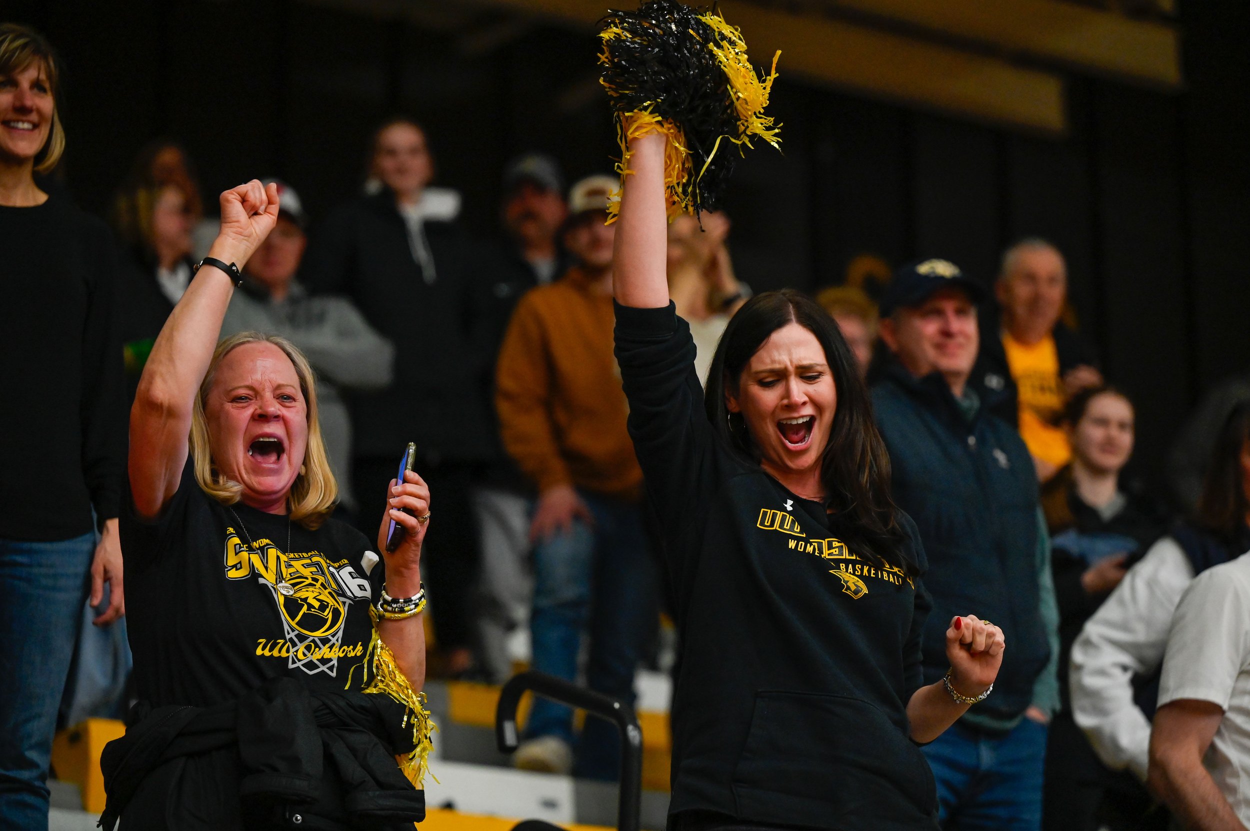 Karen and Lisa Fischer celebrate as UW-Oshkosh is moments from winning a game that will earn them a place in the Sweet 16 of the 2025 NCAA Division III tournament at Kolf Sports Center in Oshkosh, Wisconsin on March 8, 2025. Karen was there to suppor