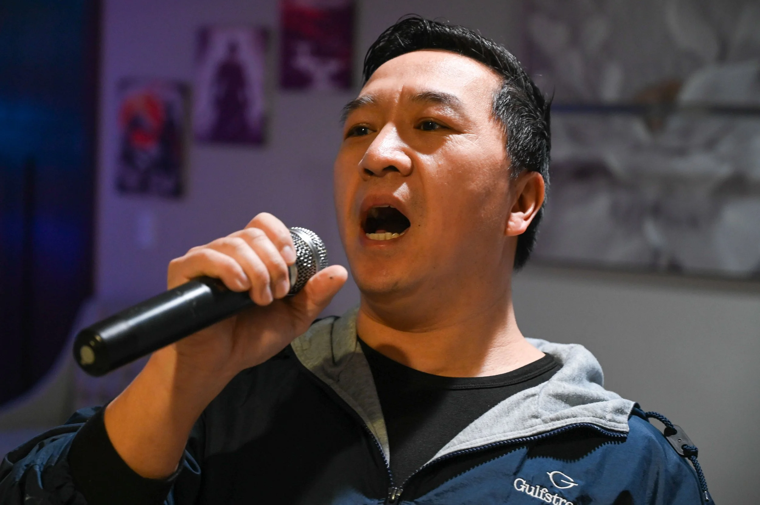 While his wife is at work, Sher Xiong practices karaoke in his basement in Appleton, Wis., Tuesday, March 10, 2026. Xiong works 4 days a week at Gulfstream, and when his wife is gone, he often spends time hunting, fishing, doing yard work, or practic