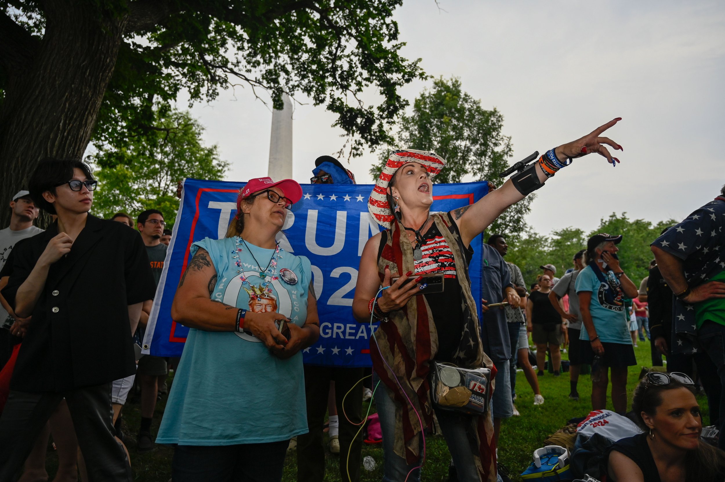 A group watches U.S. Army soldiers march through the military parade in Washington D.C., on June 14, 2025. At least one person from the group created content for "Soup Mama Official" social media, which states they are a "a non-profit organization th