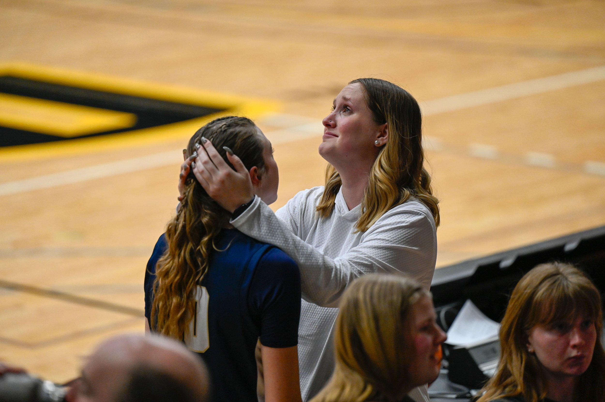 Alli Born, a forward for Bethel University's women's basketball team, is comforted after a game against UW-Oshkosh. Bethel lost to UWO by 59-49 that night.
